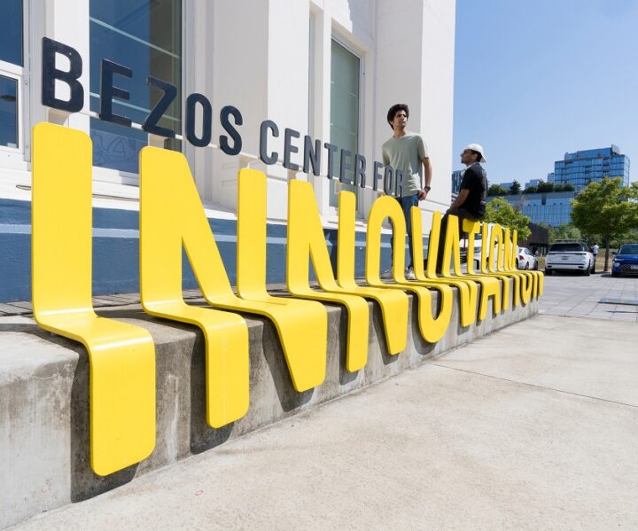 Co-op studnet in front of Bezos Center for innovation building